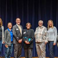 faculty posing on stage